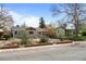 Charming single-story home with well-maintained front yard landscaping and mature trees at 3368 S Corona St, Englewood, CO 80113