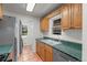 Functional kitchen featuring a double basin sink, stainless steel appliances, and practical tiled flooring at 3368 S Corona St, Englewood, CO 80113