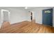 Well-lit living area with gleaming hardwood floors, a ceiling fan, and an arched doorway at 3368 S Corona St, Englewood, CO 80113