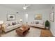 Bright living room with hardwood floors, neutral paint, ceiling fan, and contemporary furnishings at 3368 S Corona St, Englewood, CO 80113