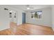 Inviting living room featuring hardwood floors, a ceiling fan, a large window, and a charming archway at 3368 S Corona St, Englewood, CO 80113