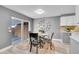 Dining room with a modern table set and sliding glass door to the backyard at 7902 Meade St # A10, Westminster, CO 80030