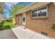 Brick exterior of home with access door, window, and concrete patio at 7902 Meade St # A10, Westminster, CO 80030