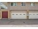 View of the two-car garage and door entrance on the front side of the home at 7902 Meade St # A10, Westminster, CO 80030