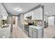 Modern kitchen with stainless steel appliances, white cabinets, and a stylish backsplash at 7902 Meade St # A10, Westminster, CO 80030