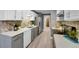 Modern kitchen boasts stainless steel appliances, quartz countertops, mosaic backsplash, and gray cabinets at 7902 Meade St # A10, Westminster, CO 80030