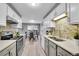 Bright eat-in kitchen features white cabinets, gray countertops, stainless appliances, and adjacent dining area at 7902 Meade St # A10, Westminster, CO 80030