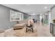 Bright living room with modern furniture, a large window, and wood floors at 7902 Meade St # A10, Westminster, CO 80030