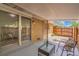 View of the enclosed patio area with glass sliding door, furniture, and privacy fencing at 7902 Meade St # A10, Westminster, CO 80030
