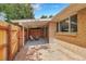Cozy covered patio with chairs, a small table, and views of the backyard at 7902 Meade St # A10, Westminster, CO 80030