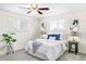 Bedroom featuring a ceiling fan and comfortable bed with white comforter and blue pillows at 3408 S Kittredge St, Aurora, CO 80013