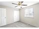 Bright bedroom features neutral carpet, a ceiling fan, and a double door closet at 3408 S Kittredge St, Aurora, CO 80013