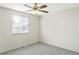 Bedroom featuring ceiling fan, large window, and neutral walls at 3408 S Kittredge St, Aurora, CO 80013
