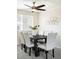 Well-lit dining area boasts a modern chandelier and table that seats six at 3408 S Kittredge St, Aurora, CO 80013