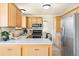 Efficient kitchen with stainless steel appliances, ample counter space, and wood cabinetry at 3408 S Kittredge St, Aurora, CO 80013