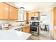 Efficient kitchen with stainless steel appliances, ample counter space, and wood cabinetry at 3408 S Kittredge St, Aurora, CO 80013