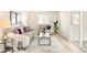 Bright living room with modern decor featuring a couch, love seat, large window and decorative rug at 3408 S Kittredge St, Aurora, CO 80013