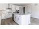 Modern kitchen with stainless steel appliances, white cabinetry, and a center island at 25204 E Warren Pl, Aurora, CO 80018