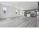 Open-concept living room featuring hardwood floors, large windows, and access to the kitchen at 25204 E Warren Pl, Aurora, CO 80018