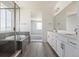 Bright bathroom features double sink vanity, a glass enclosed shower, and luxury fixtures at 25204 E Warren Pl, Aurora, CO 80018