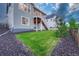 Well-maintained yard with a freshly cut lawn, trees, and stone accents surrounding the house at 2775 Morningbird Ln, Castle Rock, CO 80109