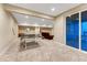 Open basement with rec area, ping pong table, and glass sliding door to backyard at 2775 Morningbird Ln, Castle Rock, CO 80109