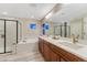 Bathroom boasts double sinks, modern fixtures, stylish vanity, tub, and a glass shower at 2775 Morningbird Ln, Castle Rock, CO 80109