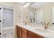 Bathroom boasts double sinks, modern fixtures, stylish vanity, and tub with marble tiling at 2775 Morningbird Ln, Castle Rock, CO 80109