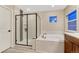 Bright bathroom featuring glass shower, tub, and modern fixtures at 2775 Morningbird Ln, Castle Rock, CO 80109