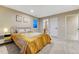 Comfortable bedroom features a plush bed, bedside table, carpet, and two pieces of wall art at 2775 Morningbird Ln, Castle Rock, CO 80109