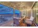 Relaxing covered deck features stylish outdoor furniture, string lights, and stunning scenic views at 2775 Morningbird Ln, Castle Rock, CO 80109