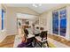 Dining room with view into the kitchen featuring glass table, modern chairs, area rug, and outside view at 2775 Morningbird Ln, Castle Rock, CO 80109