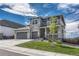 Charming two-story home with a three-car garage, stone accents, and a welcoming front porch at 2775 Morningbird Ln, Castle Rock, CO 80109
