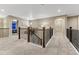 Spacious hallway features carpet, decorative iron railing and trim, and doorways to bedrooms at 2775 Morningbird Ln, Castle Rock, CO 80109