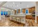Bright kitchen with island, stainless appliances, wood cabinets, and view into the adjacent dining area at 2775 Morningbird Ln, Castle Rock, CO 80109