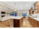 Spacious open concept kitchen features an island with seating, stainless appliances, and connects to living room at 2775 Morningbird Ln, Castle Rock, CO 80109