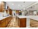 Large kitchen with island and breakfast bar, stainless steel appliances, wooden cabinets, and open floor plan at 2775 Morningbird Ln, Castle Rock, CO 80109