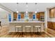 Modern kitchen featuring a center island with counter seating, stainless appliances, and wood cabinets at 2775 Morningbird Ln, Castle Rock, CO 80109