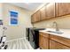 Well-equipped laundry room featuring modern washer and dryer units and ample cabinetry at 2775 Morningbird Ln, Castle Rock, CO 80109