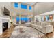 Spacious living room featuring a fireplace, large sofa, area rug, and bright windows with a view at 2775 Morningbird Ln, Castle Rock, CO 80109