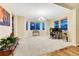 Spacious living room with a large chandelier, bright windows, and neutral carpet at 2775 Morningbird Ln, Castle Rock, CO 80109