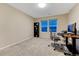 Bright home office includes a large desk, carpet, and a black bookshelf at 2775 Morningbird Ln, Castle Rock, CO 80109