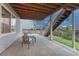 Cozy covered patio with outdoor seating and stairs leading to an upper deck, perfect for relaxing at 2775 Morningbird Ln, Castle Rock, CO 80109