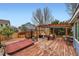 A spacious wooden deck features a hot tub and a pergola-covered seating area for relaxation at 5163 Apache Creek Rd, Castle Rock, CO 80109