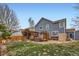 Large backyard with a wooden deck, hot tub, pergola, and green grass at 5163 Apache Creek Rd, Castle Rock, CO 80109