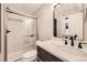 Modern bathroom featuring a glass-enclosed shower and sleek vanity with matte black fixtures at 5163 Apache Creek Rd, Castle Rock, CO 80109