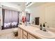 Standard bathroom features a dual sink vanity, toilet, and a shower/tub combination with a striped shower curtain at 5163 Apache Creek Rd, Castle Rock, CO 80109