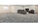 Finished basement with plush carpeting, comfortable seating, and a bright window at 1403 Hart Ln, Elizabeth, CO 80107