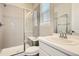 This bathroom features a glass shower enclosure with bench, a modern vanity, and a large window at 1403 Hart Ln, Elizabeth, CO 80107
