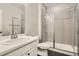 Clean bathroom featuring a glass shower enclosure, a single sink vanity, and neutral-colored tile at 1403 Hart Ln, Elizabeth, CO 80107